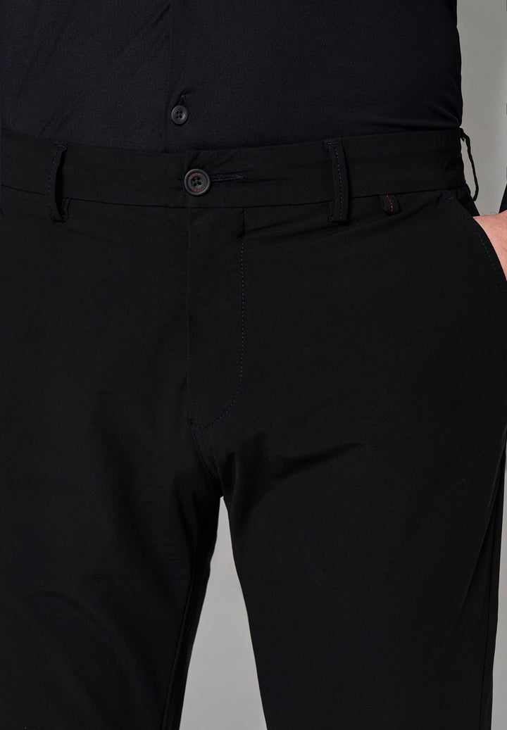 Detailaufnahme der schwarzen Herren Funktionshose mit Knopfverschluss und Gürtelschlaufen. Elastisches Material für optimale Bewegungsfreiheit.